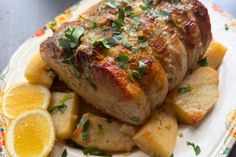 a close up of a plate of food with meat and potatoes on it, garnished with parsley