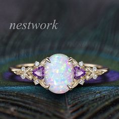 ♠ Item Info: The default one is solid 14k gold with lab opal. ✦ Center stone: 7x9mm oval lab opal. ✦ Side stones: Trillion 3mm amethyst and 1.3mm moissanites or real diamonds. ✦ Band width: about 1.4mm. About Option Box(Gold Karat-Side Stones): Gold Karat: 10k,14k or 18k. Choose platinum or silver when you're nickle allergic. Stones: The Center stone is a hexagon blue sandstone. Side Stone will be black spinels, moissanites or diamonds. ♠ Custom order,rush order or payment plan accepted. ♠ Processing Time: All items are made to order by hand made,which need 2-3 weeks processing time of handmade craft after we receive your payment. For special design one,it may need 1 month. ♠ We offer 30 days warranty on all of our items.The stones on out shop are incredibly strong and sturdy. For any ques Elegant Purple Opal Ring For Anniversary, Elegant Purple Opal Anniversary Ring, Purple Opal Promise Ring, Rings Designs For Women Gold, Cluster Diamond Ring, Engagement Ring Women, Diamond Ring Engagement, Ring Cluster, Blue Sandstone