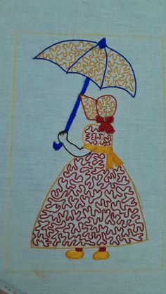 a woman with an umbrella is embroidered on a piece of cloth, which has been stitched onto it