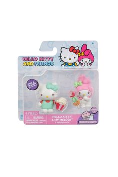 two hello kitty figurines in plastic packaging