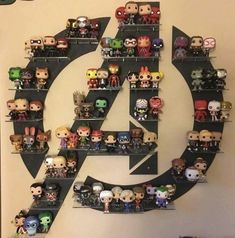 the avengers logo is surrounded by many pop - up action figures on shelves in front of a wall