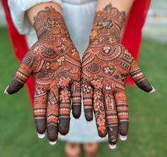 two hands with henna designs on them