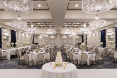 a large banquet room with chandeliers and tables