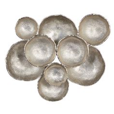 six silver plates sitting on top of each other in the shape of four circles,