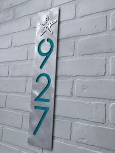 a metal sign on the side of a white brick wall that reads 2090 with a star