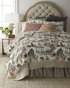 a bed with a white headboard and beige comforter on top of it in a bedroom