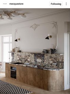 a kitchen with marble counter tops and wooden cabinets