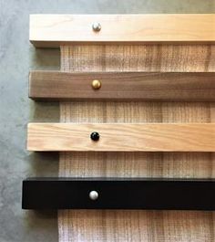 three different types of wood with metal knobs