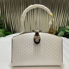 Beautiful Little Evening Purse. White Satin With Little Metal Dots In Shape Of 3 Dimensional Square, Lock Ornate With Crystals And The Metal Handle Carved. Inside Is One Pocket With Zipper. 5 Inches Tall, 6 1/2 Inches Wide. Very Elegant Little Purse. Luxury White Clutch Shoulder Bag, White Satchel Evening Bag With Detachable Strap, White Satchel Evening Bag For Party, White Luxury Clutch Bag, Luxury White Clutch Bag, White Satchel Evening Bag, White Evening Shoulder Bag With Detachable Handle, White Clutch Bag With Detachable Handle, White Satchel Shoulder Bag For Party