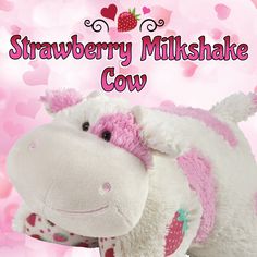 a stuffed animal that is next to a strawberry milkshake cow with the words strawberry milkshake cow on it