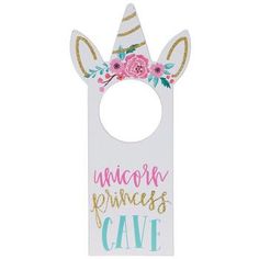 a white door hanger with pink flowers and unicorn ears on it's face