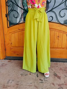 Elevate your style with our "She Stands Out" pants. These high-waisted palazzo pants offer both comfort and airflow, perfect for any occasion. The self-tie in the front and smocked back add a touch of elegance to these vibrant lime-colored pants. Feel confident and stand out in the crowd with our statement piece. Paired with our 'Petal Picking' Top and our 'Work of Art' Top Inseam: 30" Model is 5'1 and has on 3" block heels Trendy Solid Bottoms With Tie Waist, Spring Solid Wide Leg Pants With Tie Waist, Green Solid Color Wide Leg Summer Pants, Summer Green Wide Leg Pants, Green Solid Color Wide Leg Pants For Summer, Summer Ankle-length Wide Leg Pants With Tie Waist, Chic Solid Color Wide Leg Pants For Vacation, Chic Wide Leg Pants In Solid Color For Vacation, Wide Leg Pants For Summer Vacation