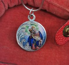 A magnificent antique silver enamel Pieta medal, petite Austrian enamel amulet on a 16 inch long sterling chain, rare Virgin Mary Catholic charm, very nicely done, in good condition, ideal for strength and protection necklace, would make a nice gift for someone special! Comes with approx. 16 inch long 925 silver necklace (see photo 5)! Material: solid silver, enamel total weight: 6.6g Measures: approx. 22 mm (0.8 inch) in diameter A stunning religious jewelry shop well worth a visit ... https:// Engraved Pendant Necklace Souvenir, Silver Medallion Necklace As Souvenir, Antique Enamel Necklace Hallmarked, Silver Medallion Necklace Souvenir, Antique Enamel Necklace With Hallmark, Silver Medallion Necklace For Souvenirs, Antique Enamel Hallmarked Necklaces, Vintage Charm Round Enamel Jewelry, Round Enamel Jewelry With Vintage Charm