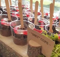 there are many plastic cups with spoons in them on the table next to each other