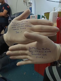 two hands that have writing on them