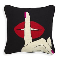 a black pillow with red lips on it and a white hand making the peace sign