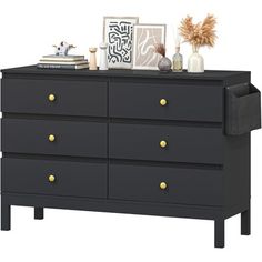 a black dresser with gold handles and drawers