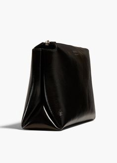 A lightweight pouch shaped by sculptural folds along the sides. The extended zipper closure allows allows for full access to the interior. Patent Leather, Calf Skin, Pouch, Sculpture, Zipper, Leather, Black