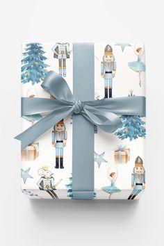 a present wrapped in blue ribbon with nutcrackers on it