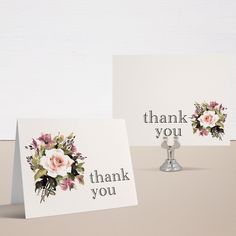 two thank you cards sitting on top of a table next to each other with flowers