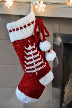 a knitted christmas stocking hanging from a fireplace