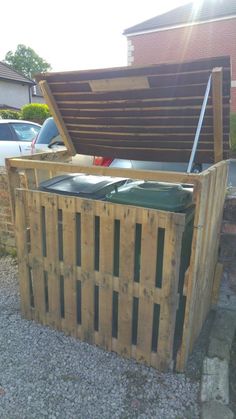 a large wooden box sitting on the side of a road