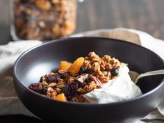 a bowl filled with yogurt, granola and fruit