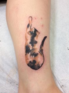 a cat tattoo on the leg of a person's foot, with one paw in the shape of a cat