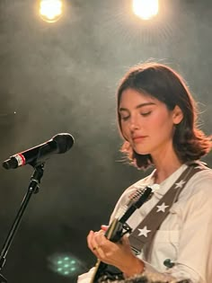 a woman standing in front of a microphone