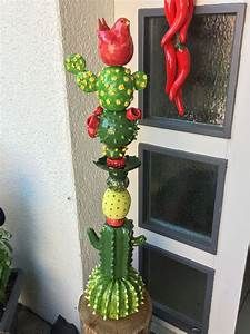 a tall green cactus plant sitting on top of a wooden stump next to a window