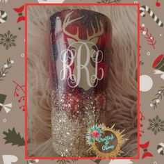 a red and gold glitter tumbler with a monogrammed deer on it