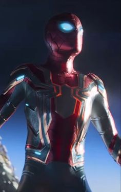 an iron man standing in front of a mountain with his hands on his hips and looking at the camera