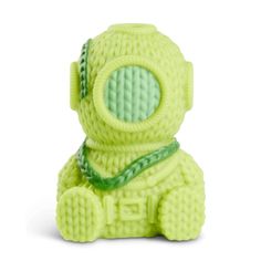 a small green toy sitting on top of a white surface