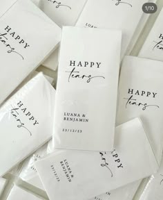 many white envelopes with black ink are stacked on top of each other and the words happy new year written in cursive writing