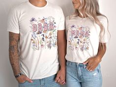 a man and woman standing next to each other wearing matching tshirts that read bada