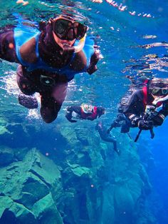 two people diving in the water with scuba gear