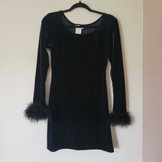 Vintage 90s Vampy Goth Punk Black Velvet Long Sleeve Mini Bodycon Dress - brand is  Stepin' Out - made from stretchy black velvet - sleeves have genuine feather cuffs - scoop neck - size small Approx flat measurements- pit to pit 16.5", waist 13.5", hips 18", sleeves 23", length 31" Very good used condition- sheds some feathers but there are still plenty left Shop Information: Worldwide shipping available. Please contact me for a shipping quote for: - orders outside of Canada/US - bundles of mor Black Velvet Club Dress, Fitted Gothic Mini Dress For Winter, Gothic Club Mini Dress For Winter, Gothic Mini Dress For Club In Winter, Gothic Mini Dress For Winter Costume Party, Fitted Winter Mini Dress With Feather Trim, Black Velvet Gothic Mini Dress, Fitted Gothic Velvet Mini Dress, Winter Black Mini Dress With Feather Trim