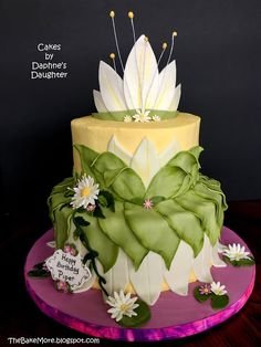 the cake is decorated with flowers and leaves