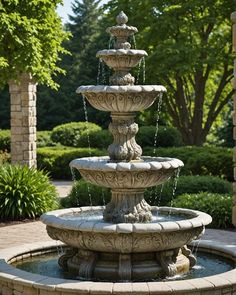 a stone fountain in the middle of a garden