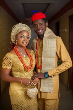 a man and woman dressed in traditional african attire