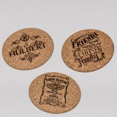 three cork coasters with different designs on them