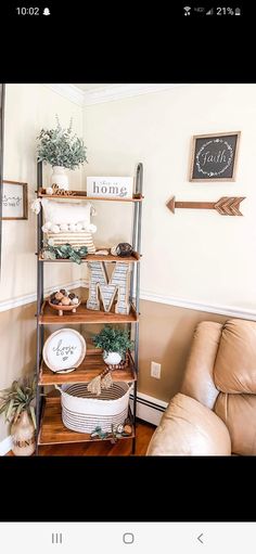 a living room filled with lots of furniture and decor on top of a wooden shelf