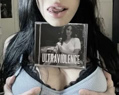 a woman holding up a cd with the words utta avolence on it