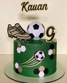 a green cake with soccer decorations on top and a name that reads kauaan 99