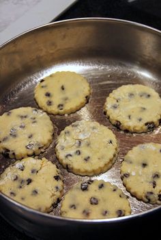 cookies are cooking in a pan on the stove