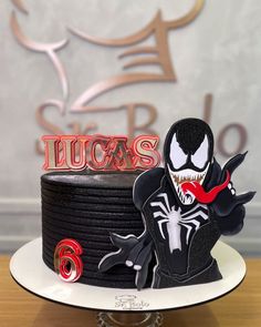 a spiderman cake with the name lucas on it and an image of a demon