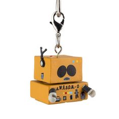 two yellow boxes with faces on them are hanging from a metal chain that is attached to a hook