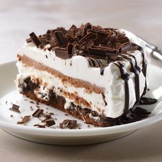 a piece of cake on a plate with chocolate shavings