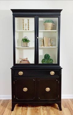 a black china cabinet with two glass doors