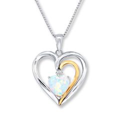 A lab-created, heart-shaped opal is topped with a single shimmering diamond and accented with a ribbon of 10K yellow gold at the center of this pretty necklace for her. A heart-shaped frame of sterling silver surrounds the centerpiece. The pendant sways from an 18-inch box chain that secures with a lobster clasp. White Heart-shaped Birthstone Necklace, White Heart-shaped Birthstone Jewelry, White Birthstone Heart Pendant Jewelry, White Double Heart Birthstone Jewelry, Opal Birthstone Necklace For Anniversary, Heart Shaped Opal Jewelry For Anniversary, Heart Shaped Frame, Gold Stock, Jewelry Advice